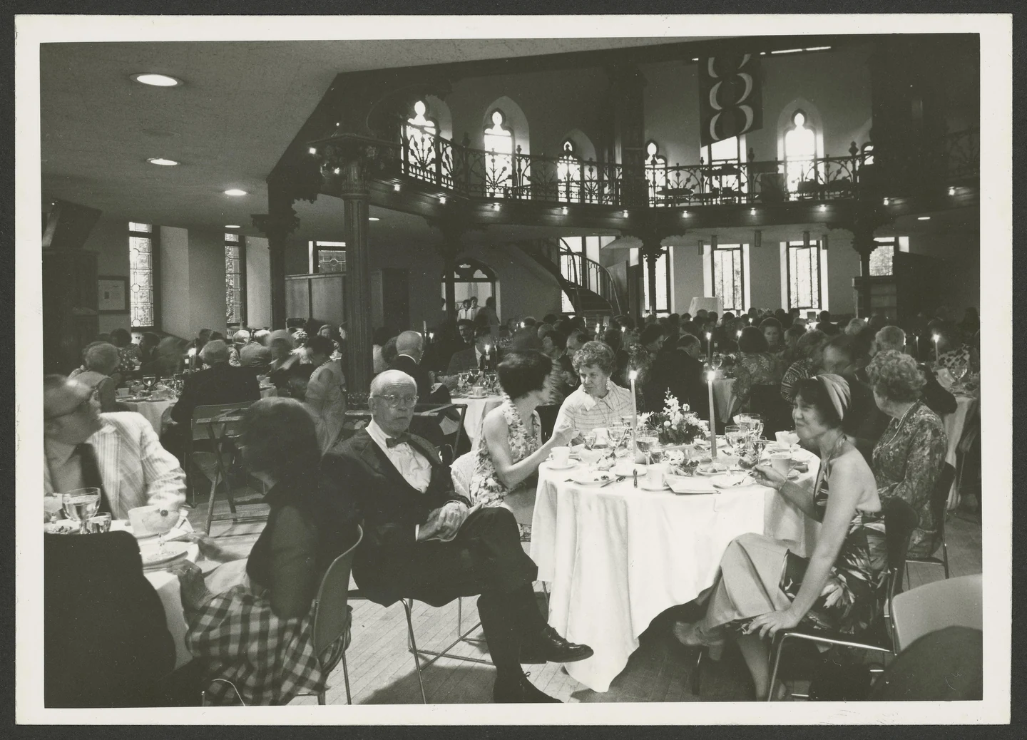 Dinner beneath the balcony and arched windows of Chancellor Green Library