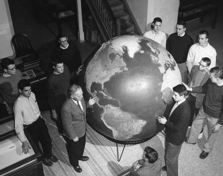 Professor Paul MacClintock teaching students around the Great Globe in Guyot Hall